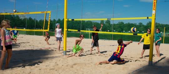 Eine Schulklasse beim Beachvolleyball spielen