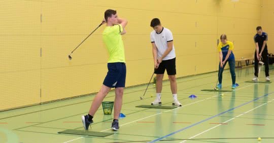 Ein Schüler übt den Golf-Schwung