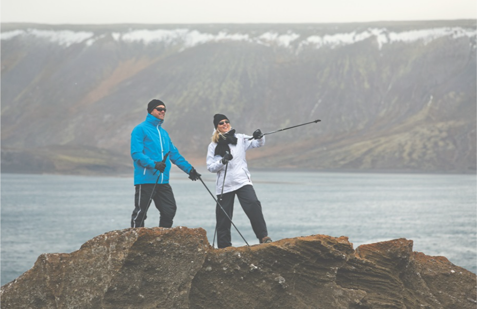 Eine Frau und ein Mann beim Nordic Walking.